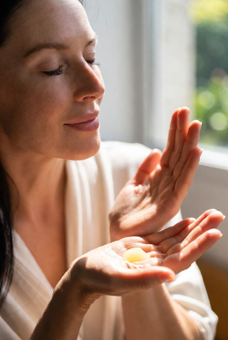 Applying InVine Botanicals natural hand cream to dry, hard-working hands