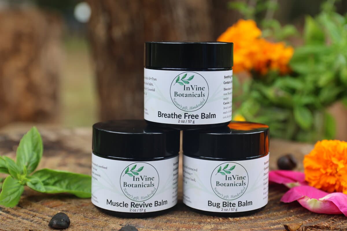 Three InVine whole-herb balms in amber glass jars, a petroleum-free alternative for slugging